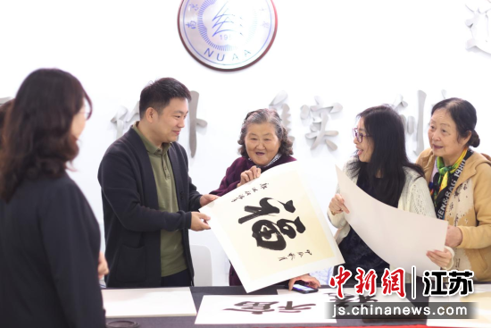 在书法送福区,青年书法家挥毫泼墨,为老同志们书写“福”“寿”等吉祥话语,送上美好祝福。中新网记者 泱波 摄 在书法送福区,青年书法家挥毫泼墨,为老同志们书写“福”“寿”等吉祥话语,送上美好祝福。中新网记者 泱波 摄